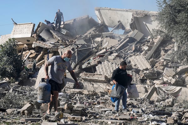 Residents of a building damaged in an Israeli airstrike return to collect their belongings in Hadath, south of Beirut, Lebanon, Sunday, Nov. 17, 2024. (AP Photo/Bilal Hussein)