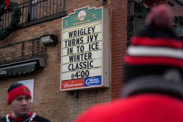 Fans hang outside of Murphy's Bleachers before the NHL Winter Classic outdoor hockey game between the Chicago Blackhawks and St. Louis Blues at Wrigley Field, Tuesday, Dec. 31, 2024, in Chicago. (AP Photo/Erin Hooley)