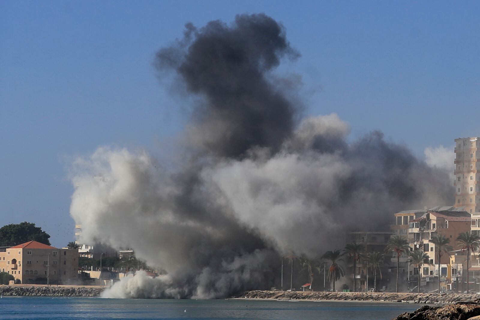 Smoke rises from buildings hit in Israeli airstrikes in Tyre, southern Lebanon, Monday, Oct. 28, 2024. (AP Photo/Mohammad Zaatari)