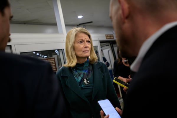 Sen. Lisa Murkowski, R-Alaska, talks with reporters as she makes her way through the Senate subway, Thursday, Jan. 23, 2025, in Washington. (AP Photo/Rod Lamkey, Jr.)