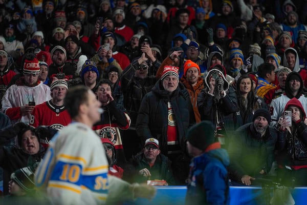 Chicago Blackhawks fans boo St. Louis Blues center Brayden Schenn (10) as Schenn leaves the ice after getting a five-minute major for fighting with Blackhawks left wing Nick Foligno (not shown) during the second period of the NHL Winter Classic outdoor hockey game at Wrigley Field, Tuesday, Dec. 31, 2024, in Chicago. (AP Photo/Erin Hooley)