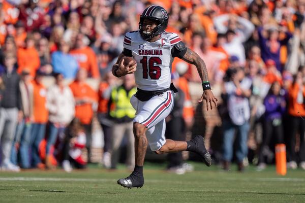 South Carolina quarterback LaNorris Sellers (16) runs with the ball in the first half of an NCAA college football game against Clemson, Saturday, Nov. 30, 2024, in Clemson, S.C. (AP Photo/Jacob Kupferman)