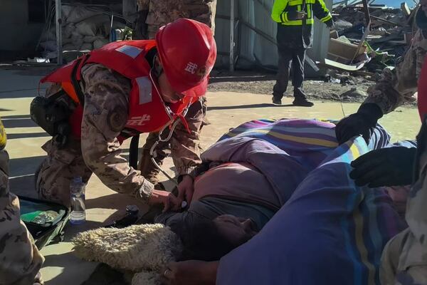 In this photo released by Xinhua News Agency, rescue workers check on an injured resident in the aftermath of an earthquake in Changsuo Township of Dingri in Xigaze, southwestern China's Tibet Autonomous Region on Tuesday, Jan. 7, 2025. (Liu Yousheng/Xinhua via AP)