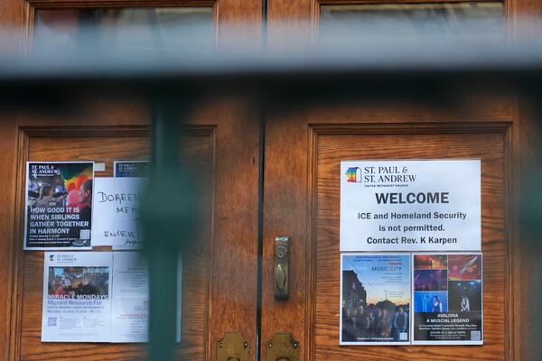 A sign that prohibits the entrance of ICE or Homeland Security is posted on a door at St. Paul and St. Andrew United Methodist Church in New York, Tuesday, Jan. 21, 2025. (AP Photo/Seth Wenig)