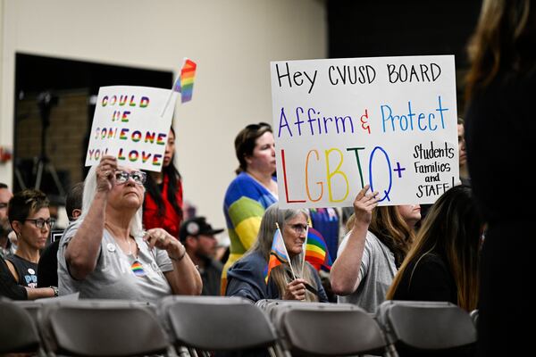 FILE - Parents, students, and staff of Chino Valley Unified School District hold up signs in favor of protecting LGBTQ+ policies at Don Antonio Lugo High School, in Chino, Calif., June 15, 2023. (Anjali Sharif-Paul/The Orange County Register via AP, File)