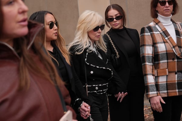 Tammi Menendez, center, the wife of Eric Menendez, leaves a courthouse after a hearing in Los Angeles, Monday, Nov. 25, 2024. (AP Photo/Jae C. Hong)