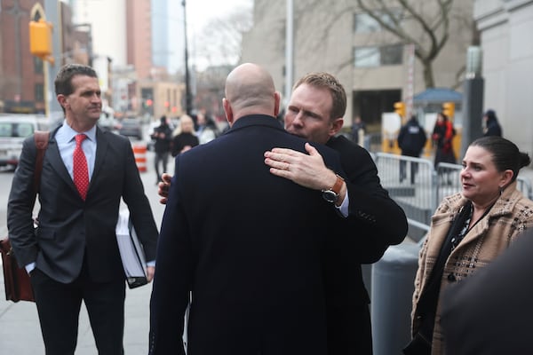 Andrew Giuliani hugs attorney Joseph Cammarata outside of federal court, Thursday, Jan. 16, 2025, in New York. (AP Photo/Heather Khalifa)