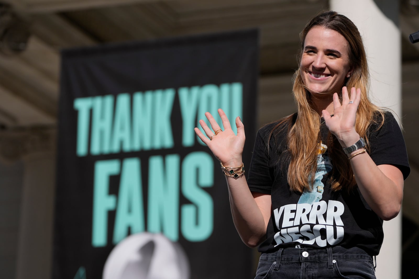 New York Liberty Sabrina Ionescu waves during a ceremony after a parade in honor of the Liberty's WNBA basketball championship at City Hall in New York, Thursday, Oct. 24, 2024. (AP Photo/Seth Wenig)