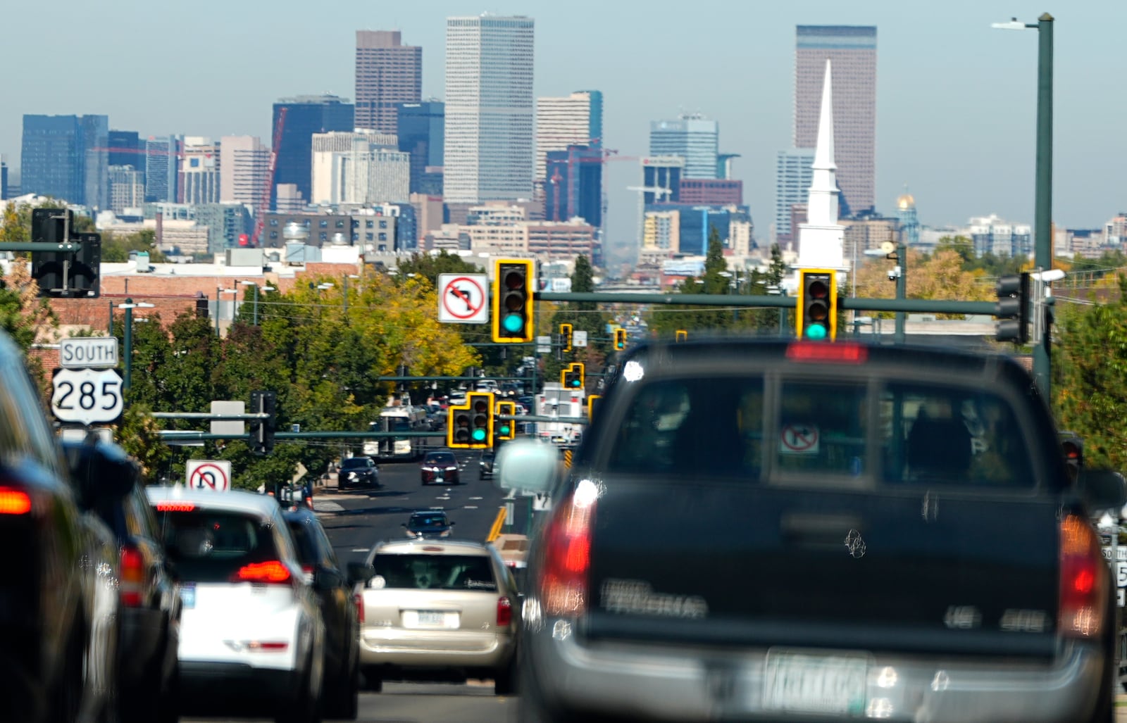 FILE - Heavy traffic moves northbound along South Broadway at Hampden Avenue as the Denver city skyline hangs in the background, Oct. 23, 2024, in Englewood, Colo. (AP Photo/David Zalubowski)