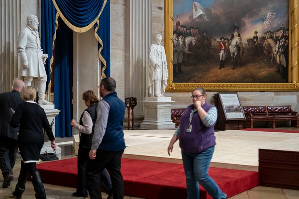 Officials inspect the construction of a stand in the Rotunda, where President-elect Donald Trump is due to take the oath of office on Monday, at the Capitol in Washington, Friday, Jan. 17, 2025. (AP Photo/Ben Curtis)