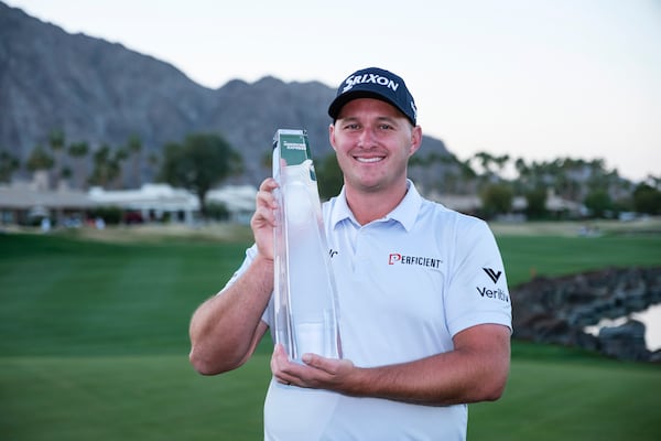 Sepp Straka holds the trophy after winning the American Express golf tournament in La Quinta, Calif., Sunday, Jan. 19, 2025. (AP Photo/William Liang)