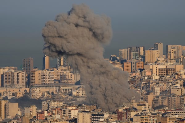 Smoke rises between buildings after an Israeli airstrike in Dahiyeh, in the southern suburb of Beirut, Lebanon, Friday, Nov. 15, 2024. (AP Photo/Hussein Malla)