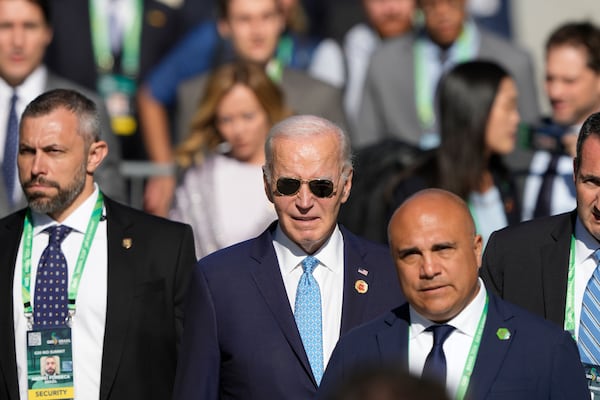 U.S. President Joe Biden arrives for a group photo during the G20 Summit in Rio de Janeiro, Monday, Nov. 18, 2024. (AP Photo/Eraldo Peres)