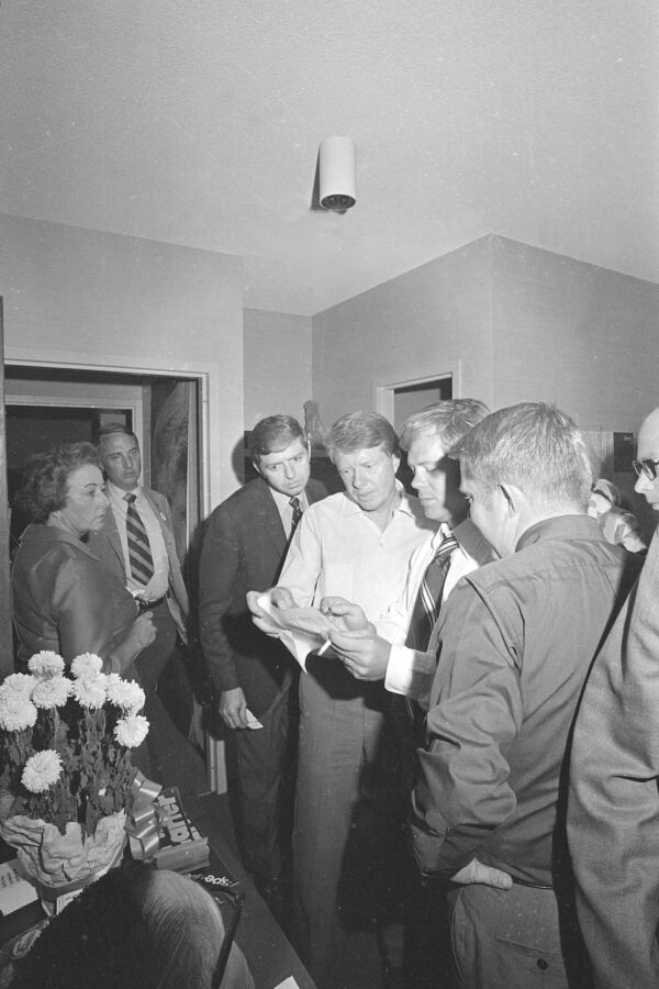 FILE - State Sen. Jimmy Carter, without tie, holds a serious conversation with his campaign workers in Atlanta on Sept. 9, 1970. (AP Photo, File)