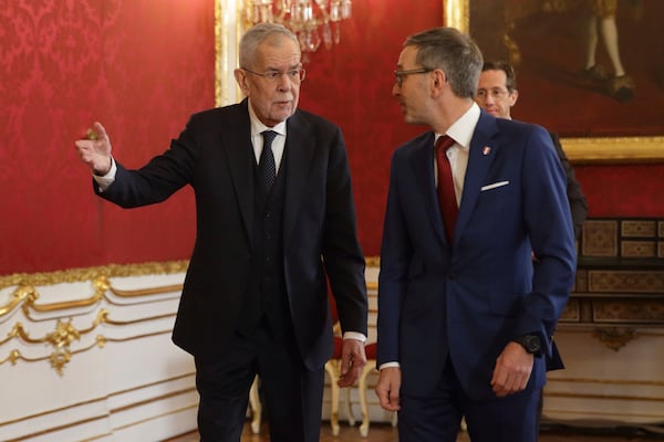 Austrian President Alexander Van der Bellen, left, welcomes head of the Freedom Party (FPOe) Herbert Kickl at his office, in Vienna, Austria, Monday, Jan. 6, 2025. (AP Photo/Heinz-Peter Bader)