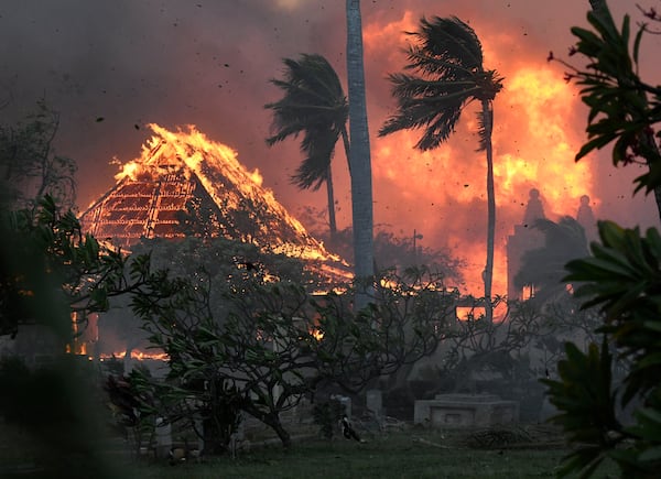 FILE - The hall of historic Waiola Church in Lahaina and nearby Lahaina Hongwanji Mission are engulfed in flames along Wainee Street, Aug. 8, 2023, in Lahaina, Hawaii. (Matthew Thayer/The Maui News via AP, File)