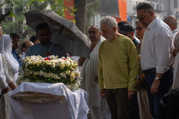 Bollywood actors Boman Irani, right, and Naseeruddin Shah pay homage to Shyam Benegal, a renowned Indian filmmaker who passed away on Monday, during Benegal's funeral in Mumbai, India, Tuesday, Dec. 24, 2024. (AP Photo/Rafiq Maqbool)