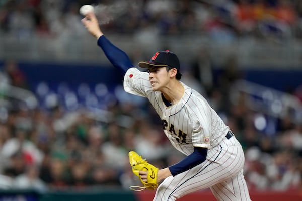 FILE- Japan's Roki Sasaki delivers a pitch during the first inning of a World Baseball Classic game against Mexico, Monday, March 20, 2023, in Miami. (AP Photo/Wilfredo Lee, File)