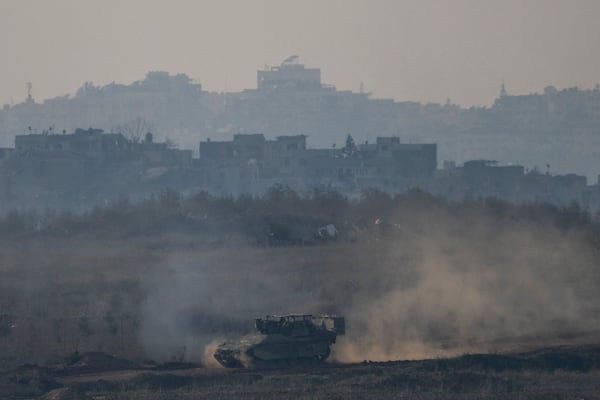 An Israeli army APC moves in the Gaza Strip as seen from southern Israel on Thursday, Jan. 16, 2025. (AP Photo/Ariel Schalit)