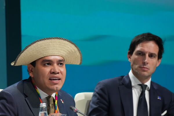 Panama Climate Envoy Juan Carlos Monterrey Gomez, left, and Wopke Hoekstra, EU climate commissioner, attend a session on climate targets during the COP29 U.N. Climate Summit, Thursday, Nov. 21, 2024, in Baku, Azerbaijan. (AP Photo/Sergei Grits)