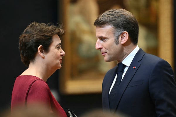 French President Emmanuel Macron speaks to the Louvre Museum director Laurence des Cars, Tuesday, Jan. 28, 2025 in Paris. French President Emmanuel Macron has announced that the Mona Lisa will get its own dedicated room inside the Louvre museum, which he said will be renovated and expanded in a major overhaul. ( Bertrand Guay, Pool via AP)