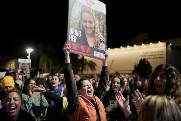 Relatives and friends of people killed and abducted by Hamas and taken into Gaza, react to the news of the hostages' release, as they gather in Tel Aviv, Israel on Sunday, Jan. 19, 2025. (AP Photo/Maya Alleruzzo)