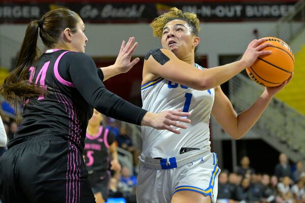 UCLA guard Londynn Jones (1) drives past Penn State guard Jill Jekot for a basket during the first half of an NCAA college basketball game Wednesday, Jan. 15, 2025, in Los Angeles. (AP Photo/Jayne Kamin-Oncea)