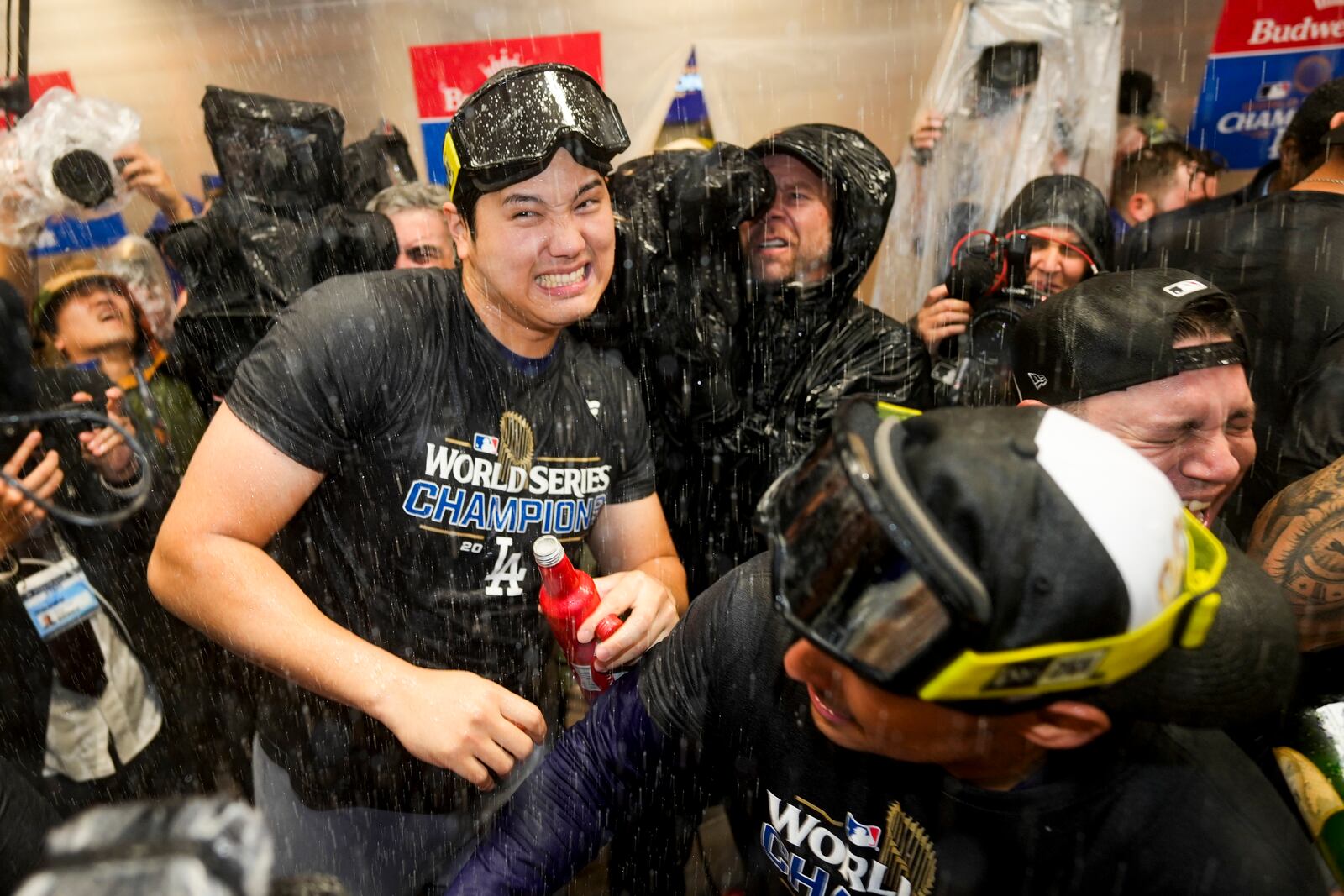 Los Angeles Dodgers' Shohei Ohtani celebrates in the locker room after their win against the New York Yankees in Game 5 to win the baseball World Series, Thursday, Oct. 31, 2024, in New York. (AP Photo/Ashley Landis)