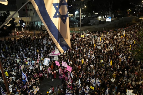 People gather to protest against Prime Minister Benjamin Netanyahu's government and call for the release of hostages held in the Gaza Strip by the Hamas militant group, in Tel Aviv, Israel, Saturday, Nov. 23, 2024. (AP Photo/Maya Alleruzzo)