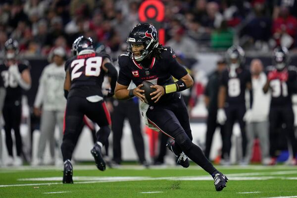 Houston Texans quarterback C.J. Stroud rolls out of the pocket against the Los Angeles Chargers during the second half of an NFL wild-card playoff football game Saturday, Jan. 11, 2025, in Houston. (AP Photo/Ashely Landis)