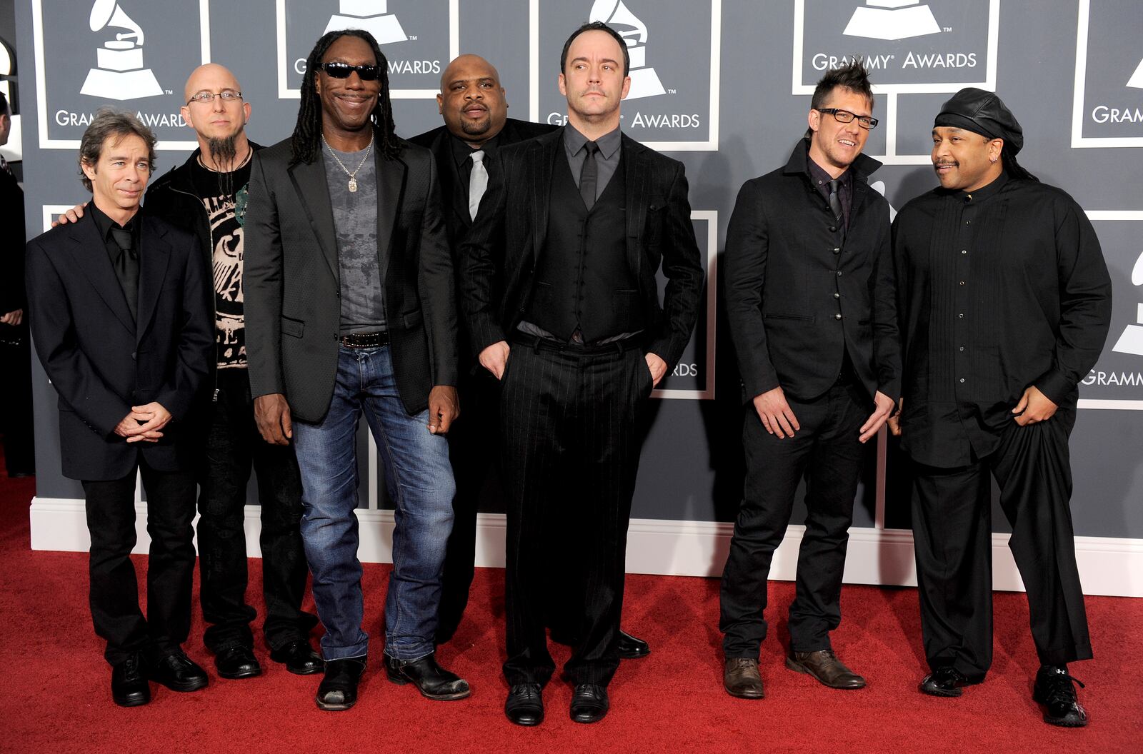 FILE - Members of the Dave Matthews Band, Tim Reynolds, Jeff Coffin, Boyd Tinsley, Rashawn Ross, Dave Matthews, Stefan Lessard and Carter Beauford arrive at the Grammy Awards in Los Angeles on Jan. 31, 2010. (AP Photo/Chris Pizzello, File)