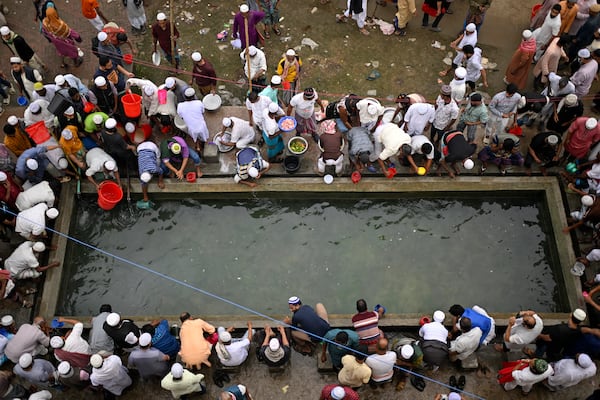 Muslim devotees perform ablutions before prayers during the first phase of the three-day Biswa Ijtema, or the World Congregation of Muslims, at the banks of the Turag river in Tongi, near Dhaka, Bangladesh, Friday, Jan. 31, 2025. (AP Photo/Mahmud Hossain Opu)