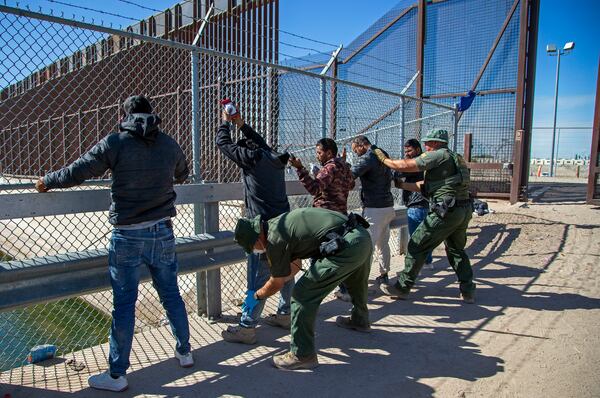 FILE - Migrants are pat down by Border Patrol agents as they enter into El Paso, Texas from Ciudad Juarez, Mexico, May 10, 2023. (AP Photo/Andres Leighton, File)