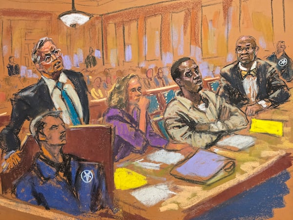 In this courtroom sketch, attorney Marc Agnifolo, left, speaks at the podium, as Alexandra Shapiro, Sean Diddy Combs, and attorney Tony Riccio, seated second left to right, listen during a hearing in federal court, Friday, Nov. 24, 2024, in New York. (Jane Rosenberg via AP)