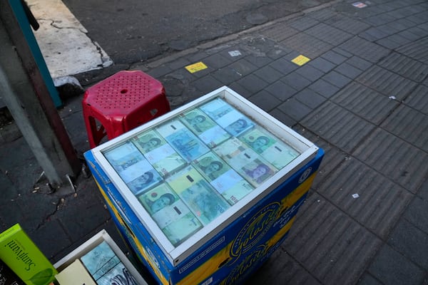 Iranian banknotes are displayed by a street money exchanger at Ferdowsi square, Tehran's go-to venue for foreign currency exchange, in downtown Tehran, Iran, Wednesday, Dec. 18, 2024. (AP Photo/Vahid Salemi)