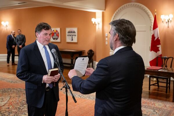 Dominic LeBlanc, front left, is sworn in as finance minister by Clerk of the Privy Council John Hannaford, right, during a ceremony at Rideau Hall in Ottawa, Ontario, Monday, Dec. 16, 2024. (Justin Tang/The Canadian Press via AP)