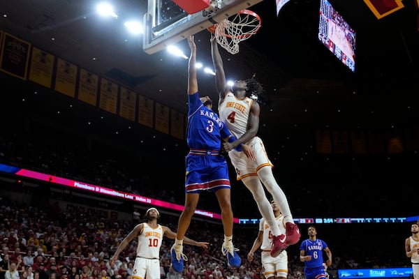 Iowa State guard Demarion Watson (4) blocks a shot by Kansas guard Dajuan Harris Jr. (3) during the first half of an NCAA college basketball game Wednesday, Jan. 15, 2025, in Ames, Iowa. (AP Photo/Charlie Neibergall)