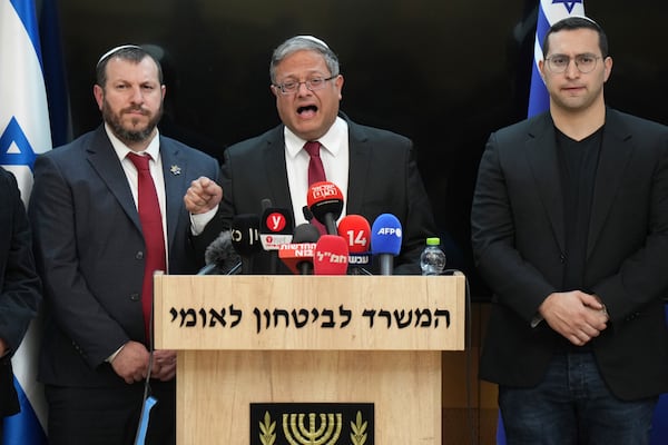 Israel's far-right National Security Minister, Itamar Ben-Gvir, center, in a statement to the media, says he will quit if Israel approves Gaza ceasefire, at his office in Jerusalem on Thursday, Jan. 16, 2025. (AP Photo/Ohad Zwigenberg)