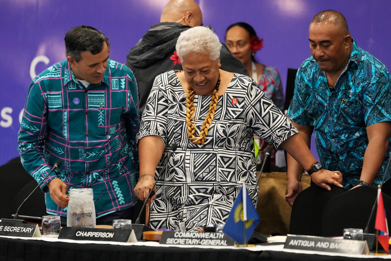 Samoan Prime Minister Afioga Fiamē Naomi Mataʻafa, center, is assisted by Assistant Secretary General of the Commonwealth Luis Franceschi, left, at the Foreign Ministers meeting at the Commonwealth Heads of Government meeting in Apia, Samoa, Thursday, Oct. 24, 2024. (AP Photo/Rick Rycroft/Pool)