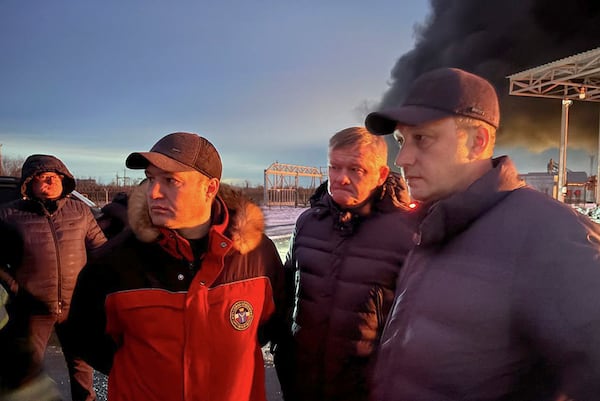 In this photo released by Governor of the Saratov region Roman Busargin telegram channel on Wednesday, Jan. 8, 2025, Governor of the Saratov region Roman Busargin, right, speaks to firefighters and rescuers at the industrial side damaged after Ukrainian drones' attack in Saratov, Russia. (Governor of the Saratov region Roman Busargin telegram channel via AP)