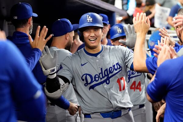 FILE - Los Angeles Dodgers' Shohei Ohtani (17) celebrates in the dugout after hitting a home run during the sixth inning of a baseball game against the Miami Marlins, Thursday, Sept. 19, 2024, in Miami. (AP Photo/Marta Lavandier, File)