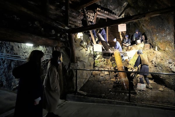 Visitors look at display at Sado Kinzan Gold Mine historic site in Sado, Niigata prefecture, Japan, Saturday, Nov. 23, 2024. (AP Photo/Eugene Hoshiko)