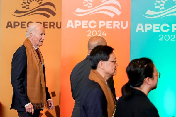 President Joe Biden walks off the stage after the taking of the leaders' group photo, during the Asia-Pacific Economic Cooperation (APEC) summit, in Lima, Peru, Saturday, Nov. 16, 2024. (AP Photo/Fernando Vergara)