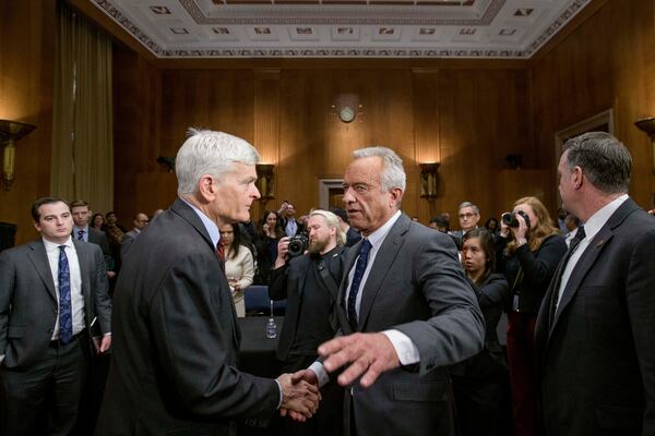 Robert F. Kennedy, Jr., right, President Donald Trump's nominee to serve as Secretary of Health and Human Services, talks with Committee Chairman Sen. Bill Cassidy, R-La., following his testimony during a Senate Committee on Health, Education, Labor and Pensions hearing for his pending confirmation on Capitol Hill, Thursday, Jan. 30, 2025, in Washington. (AP Photo/Rod Lamkey, Jr.)