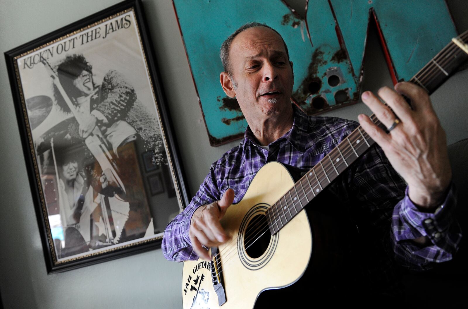 FILE - Wayne Kramer, co-founder of the protopunk Detroit band the MC5, plays a guitar at his recording studio in Los Angeles on Jan. 16, 2012. (AP Photo/Chris Pizzello, File)