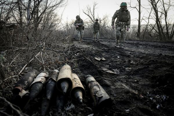 Ukrainian servicemen collect damaged ammunition on the road at the front line near Chasiv Yar town, in Donetsk region, Ukraine, Ukraine, Friday, Jan. 10, 2025. (Oleg Petrasiuk/Ukraine's 24th Mechanised Brigade via AP)