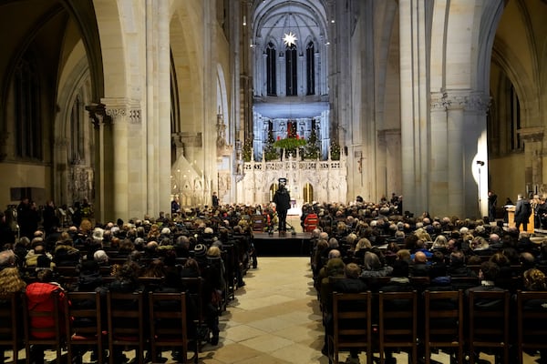 People attend a memorial service for victims of Friday's Christmas Market attack, where a car drove into a crowd, in Magdeburg, Germany, Saturday, Dec. 21, 2024. (AP Photo/Ebrahim Noroozi)