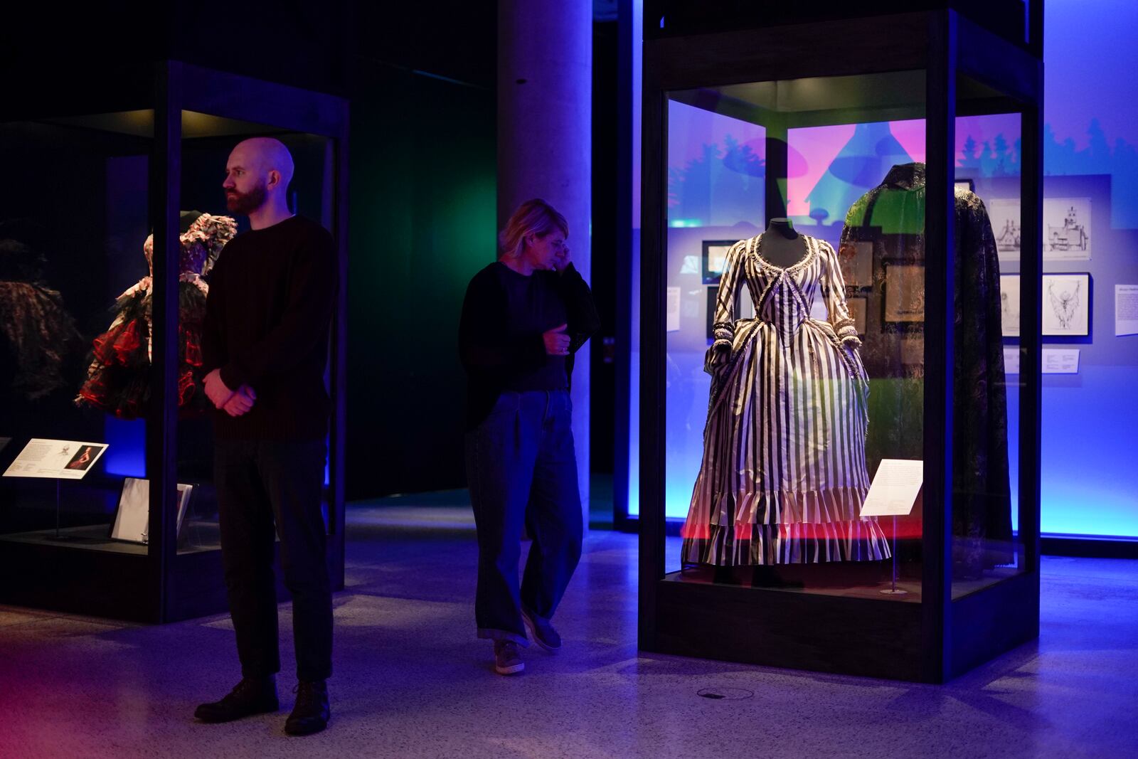 People walk at The World of Tim Burton exhibition at the Design Museum, in London, Monday, Oct. 21, 2024. The major exhibition sees Tim Burton's personal archives on display for the first time, featuring 600 items from his nearly fifty years long career. (AP Photo/Alberto Pezzali)