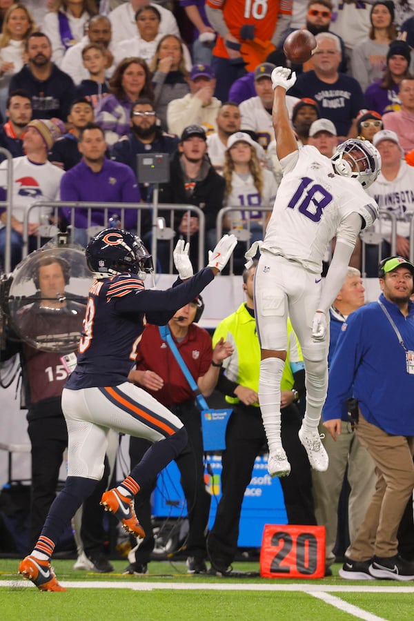 Minnesota Vikings wide receiver Justin Jefferson (18) reaches for an incomplete pass over Chicago Bears cornerback Tyrique Stevenson (29) during the second half of an NFL football game, Monday, Dec. 16, 2024, in Minneapolis. (AP Photo/Bruce Kluckhohn)