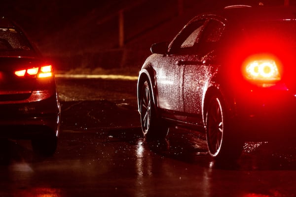 A car gets stuck trying to go up an icy Pacific Street during freezing rain in Omaha, Neb. on Friday, Dec. 13, 2024. (Chris Machian/Omaha World-Herald via AP)